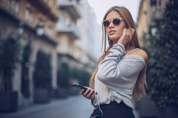istock Blond young woman in city 909068364