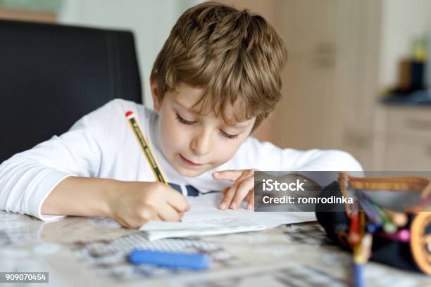 Tired Kid Boy At Home Making Homework Writing Letters With Colorful Pens Stock Photo - Download Image Now