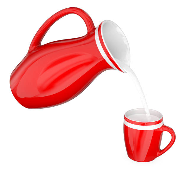 istock Milk is poured from a red jug into a mug 909070826