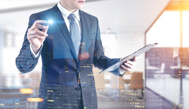 istock Businessman with a glowing marker, office 909070886