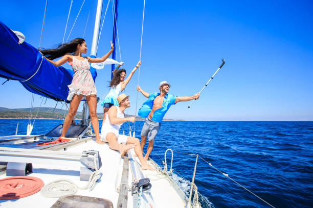 istock Young people taking selfie on yacht 909070956