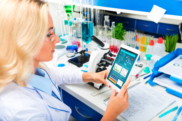 istock Young attractive woman scientist using tablet computer in the laboratory 909075160