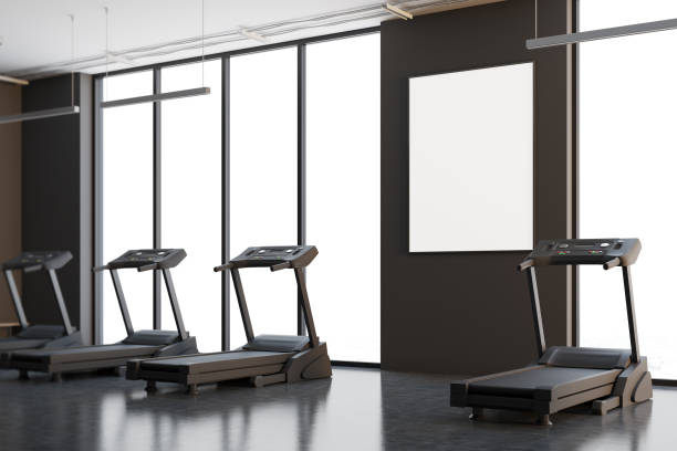 istock Four treadmills in a gray room, poster side 909075506