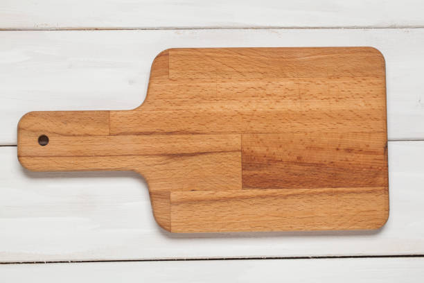 istock Cutting board on wooden white 909085226