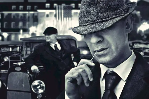 fashion bossy Italian mafia gangster in 1930's near classic car