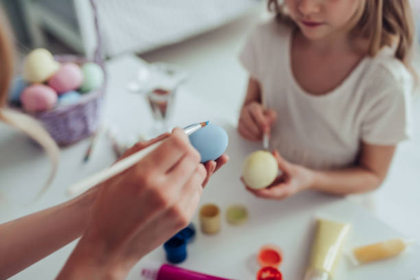 istock Mom and daughter preparing for Easter celebration 909085604