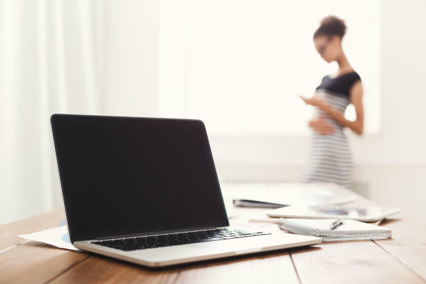 istock Businesswoman standing, using smartphone 909085662