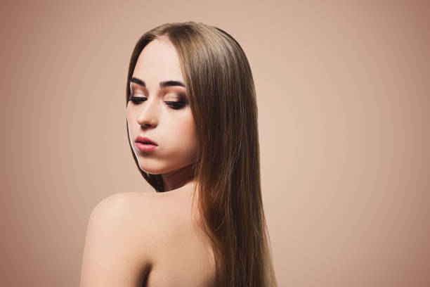 istock Beauty model on beige background, fashion shooting 909089204