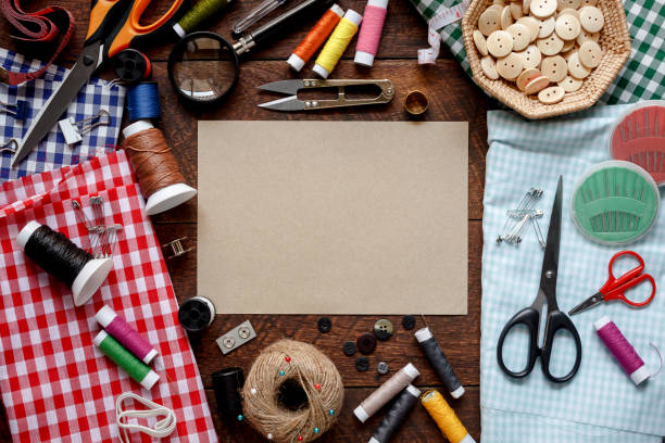 istock Top view aerial image fashion designer background concept.Flat lay sewing accessory or tailor tool work shop on modern rustic brown wooden at home office desk studio.Space for creative design mock up. 909093174