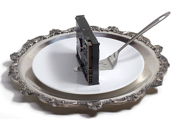 Hard drive served on a plate (isolated, clipping path) stock photo
