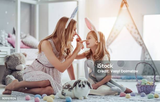 Mom And Daughter Preparing For Easter Celebration Stock Photo - Download Image Now - Easter, Family, Rabbit - Animal