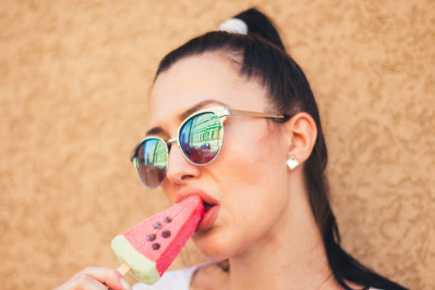 istock young woman with watermelon ice cream. 909102006