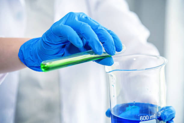 istock science laboratory researcher perform test with blue and green solution 909102306