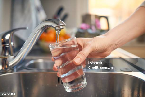 Pouring Fresh Tap Water Into A Glass Stock Photo - Download Image Now - Water, Faucet, Drinking Water