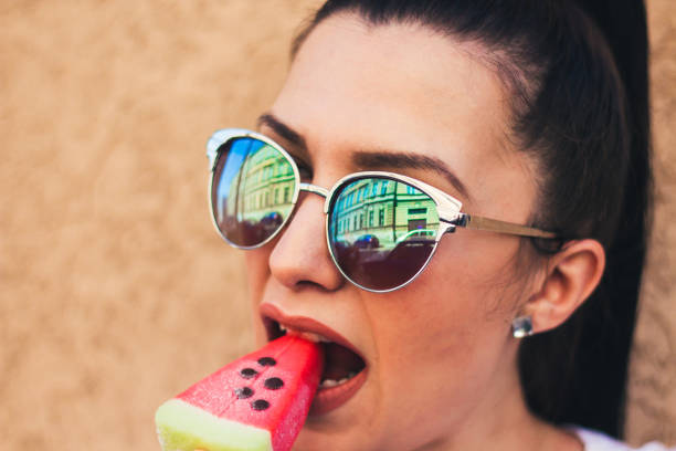 istock young woman with watermelon ice cream. 909105580