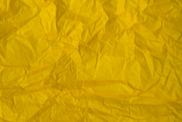 istock Crumpled yellow paper as background or texture 909105602