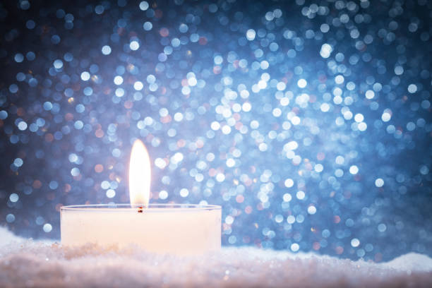 istock Chistmas candle glowing on glitter background. 909106310