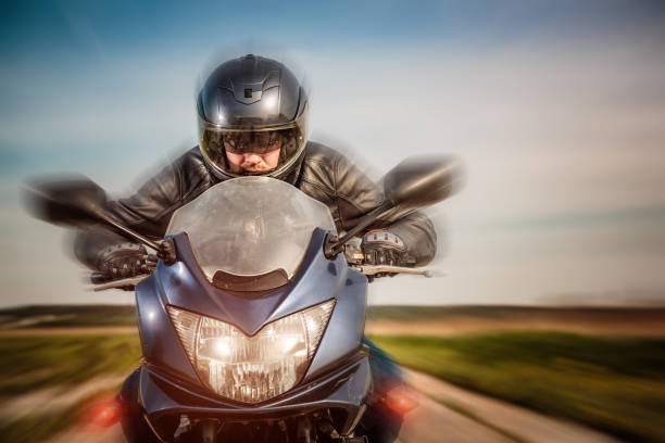 istock Biker racing on the road 909109014