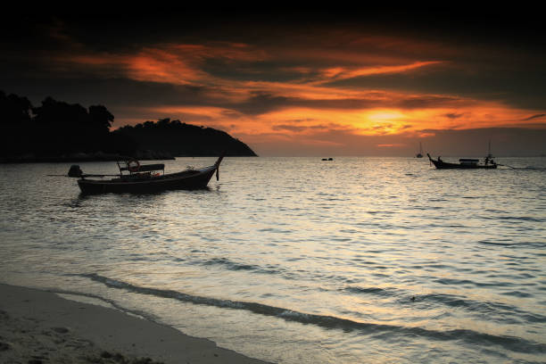 istock Silhouette boat during sunset at Lipe 909109694