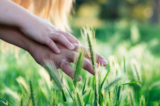 istock Mother and daughter touching grass 909110062