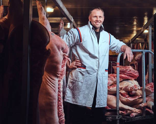 istock The butcher in a meat factory. 909110256