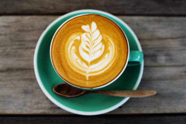 istock Cappuccino coffee in a green cup 909111612