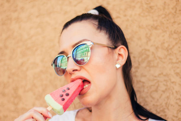 istock young woman with watermelon ice cream. 909114496