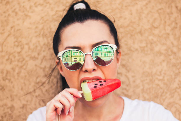 istock woman refreshing with  ice cream. 909114764