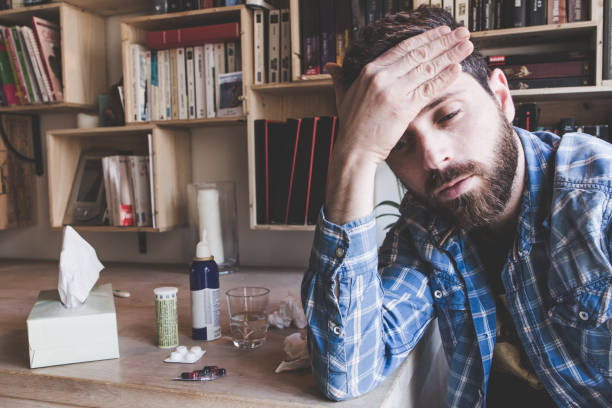 istock Sick Man. Flu. Man Caught Cold. Sneezing into handkerchief 909114792