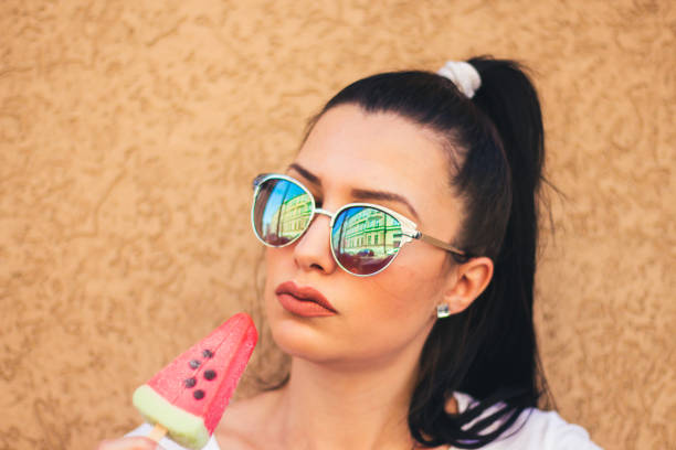 istock young woman with watermelon ice cream. 909115566