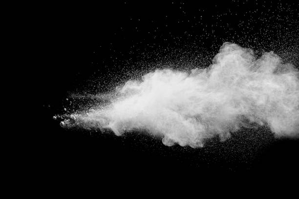Launched white particle splash on black background. Bizarre forms of of white powder explosion cloud against dark background.