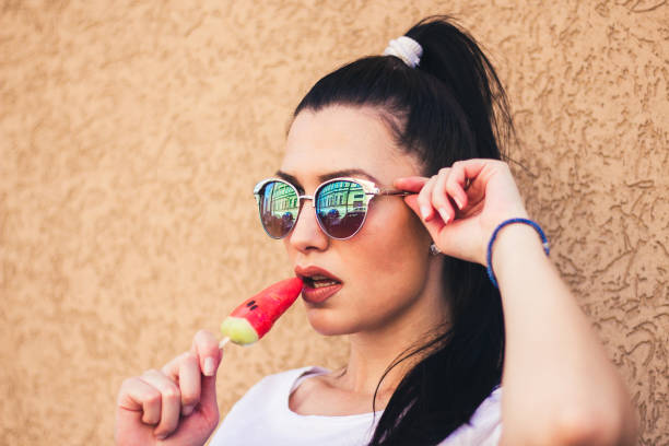 istock young woman with watermelon ice cream. 909119600