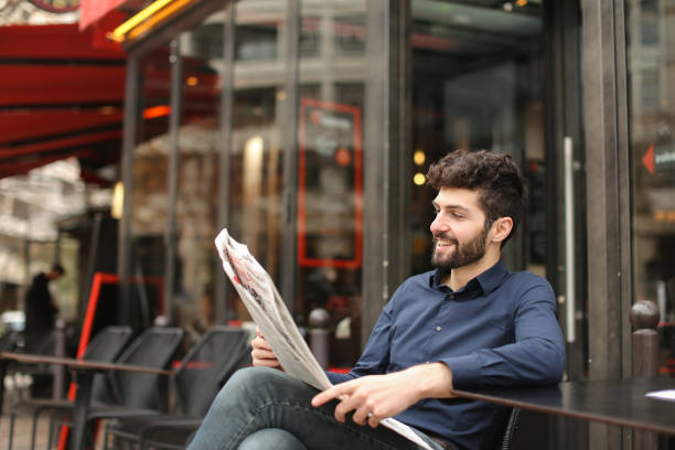 istock Prosperous businessman typing message by smartphone at cafe with 909121678