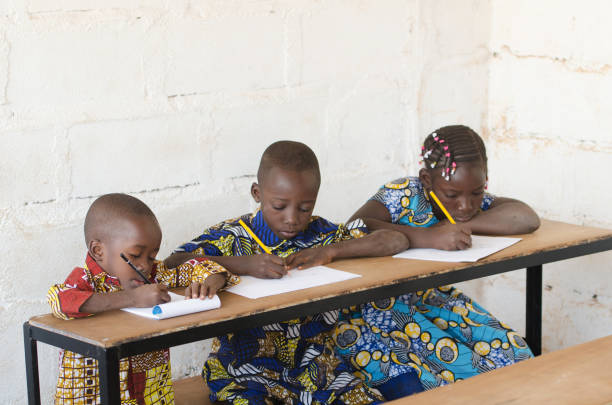 istock Three beautiful African Children in School Taking Notes during Class 909125760