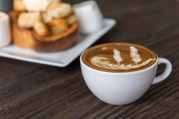 istock Hot coffee latte art cup  on wooden table 909125962