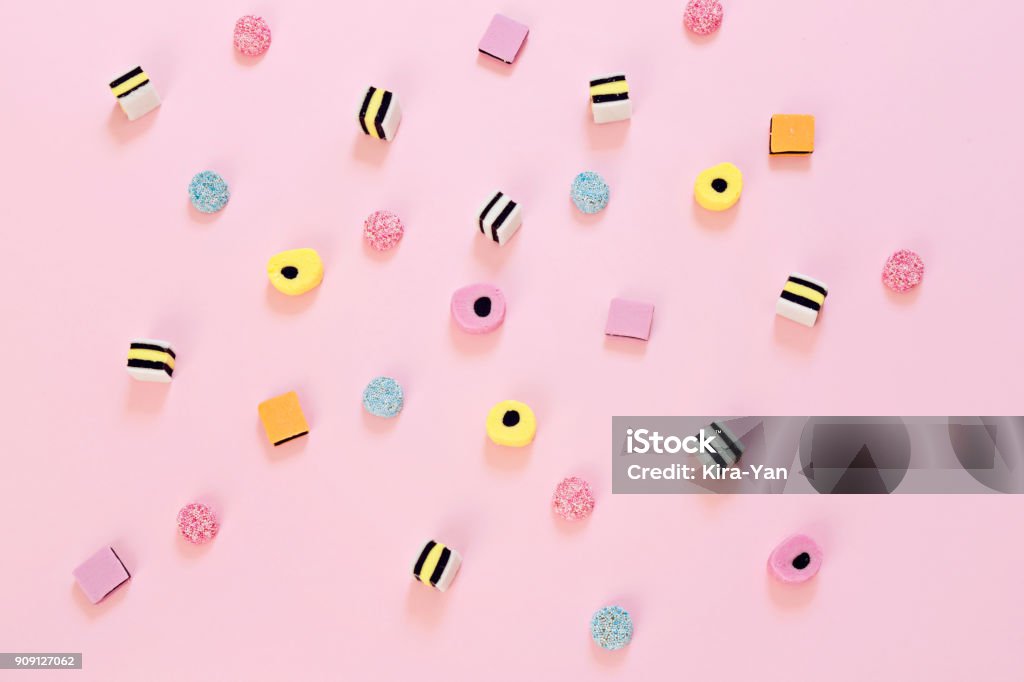 Colored candy scattered on the pink background Jelly colored candy scattered on the pink background, abstract background concept Sweet Food Stock Photo