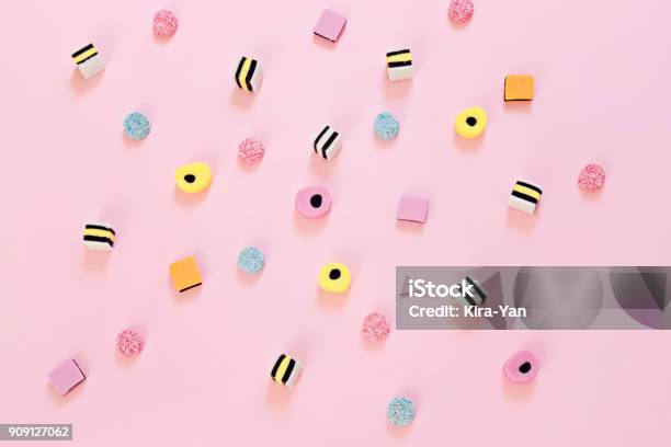 Colored Candy Scattered On The Pink Background Stock Photo - Download Image Now - Sweet Food, Multi Colored, Knolling - Concept