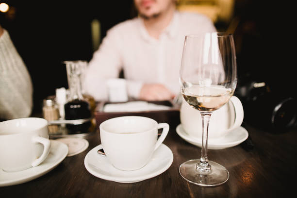 istock Coffe and vine on the twooden able in cafe 909131476