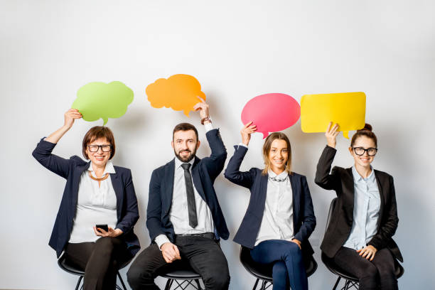 istock Business people holding colorful bubbles 909132804