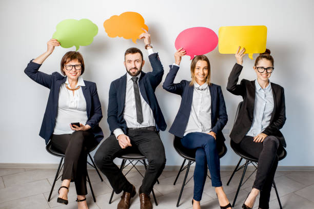 istock Business people holding colorful bubbles 909132856