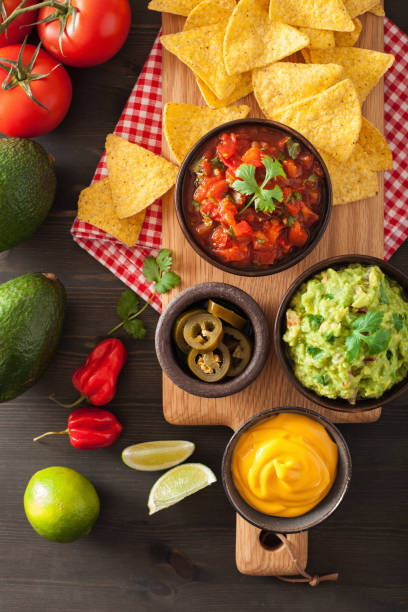 istock mexican nachos tortilla chips with guacamole, salsa and cheese dip 909133160