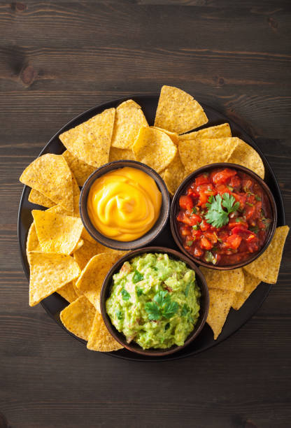 istock mexican nachos tortilla chips with guacamole, salsa and cheese dip 909133350