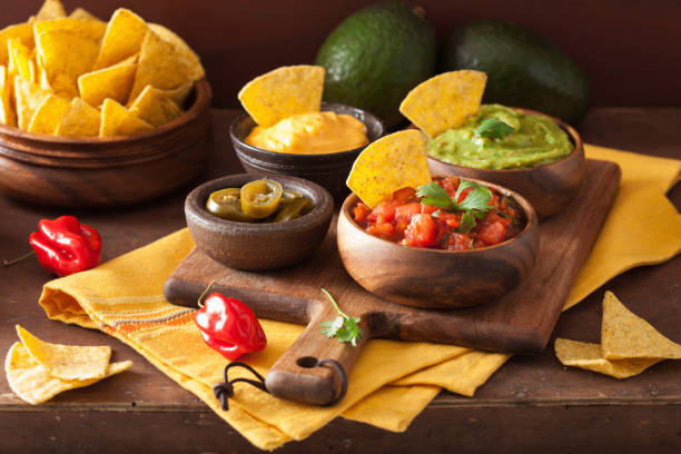 istock mexican nachos tortilla chips with guacamole, salsa and cheese dip 909133484