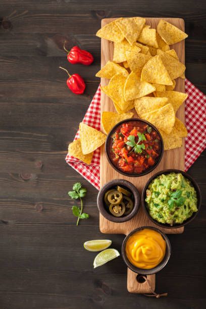 istock mexican nachos tortilla chips with guacamole, salsa and cheese dip 909133994
