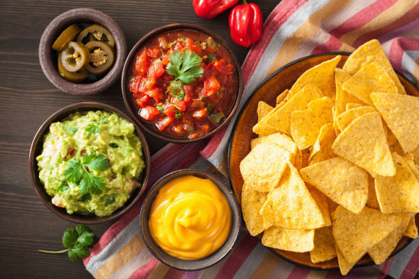 istock mexican nachos tortilla chips with guacamole, salsa and cheese dip 909134258