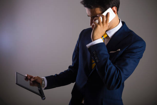 istock Businessman with smart phone, gray backgroung 909135750