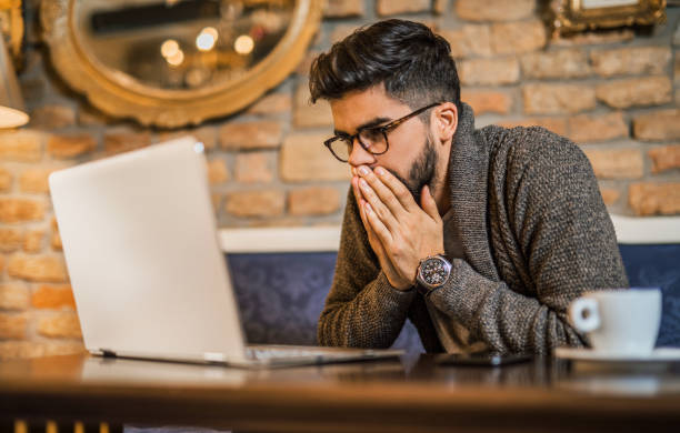 Young man looking at computer. Young man looking at computer. impatient stock pictures, royalty-free photos & images