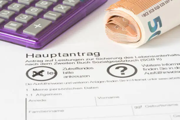 A calculator, Euro banknotes and application for Hartz 4