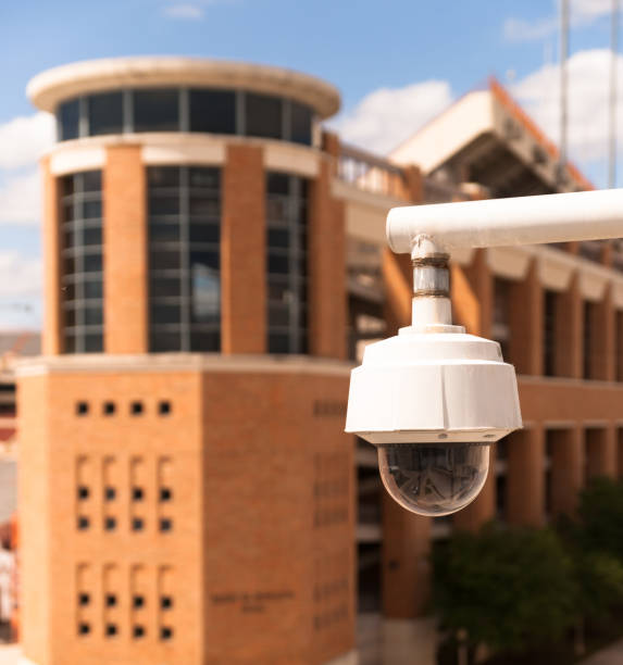 istock Video Security Camera Housing Mounted High on College Campus 909139678