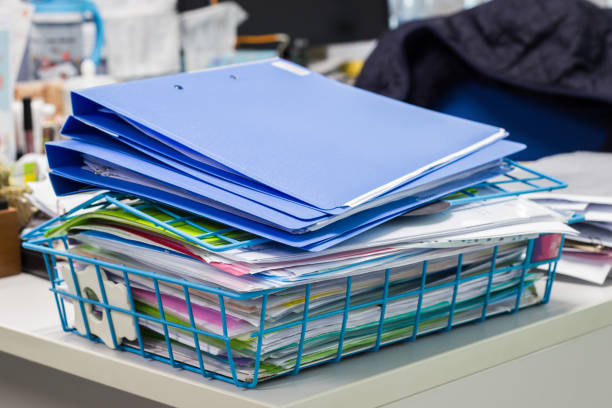istock file folder and Stack of business report paper file on the table 909145604